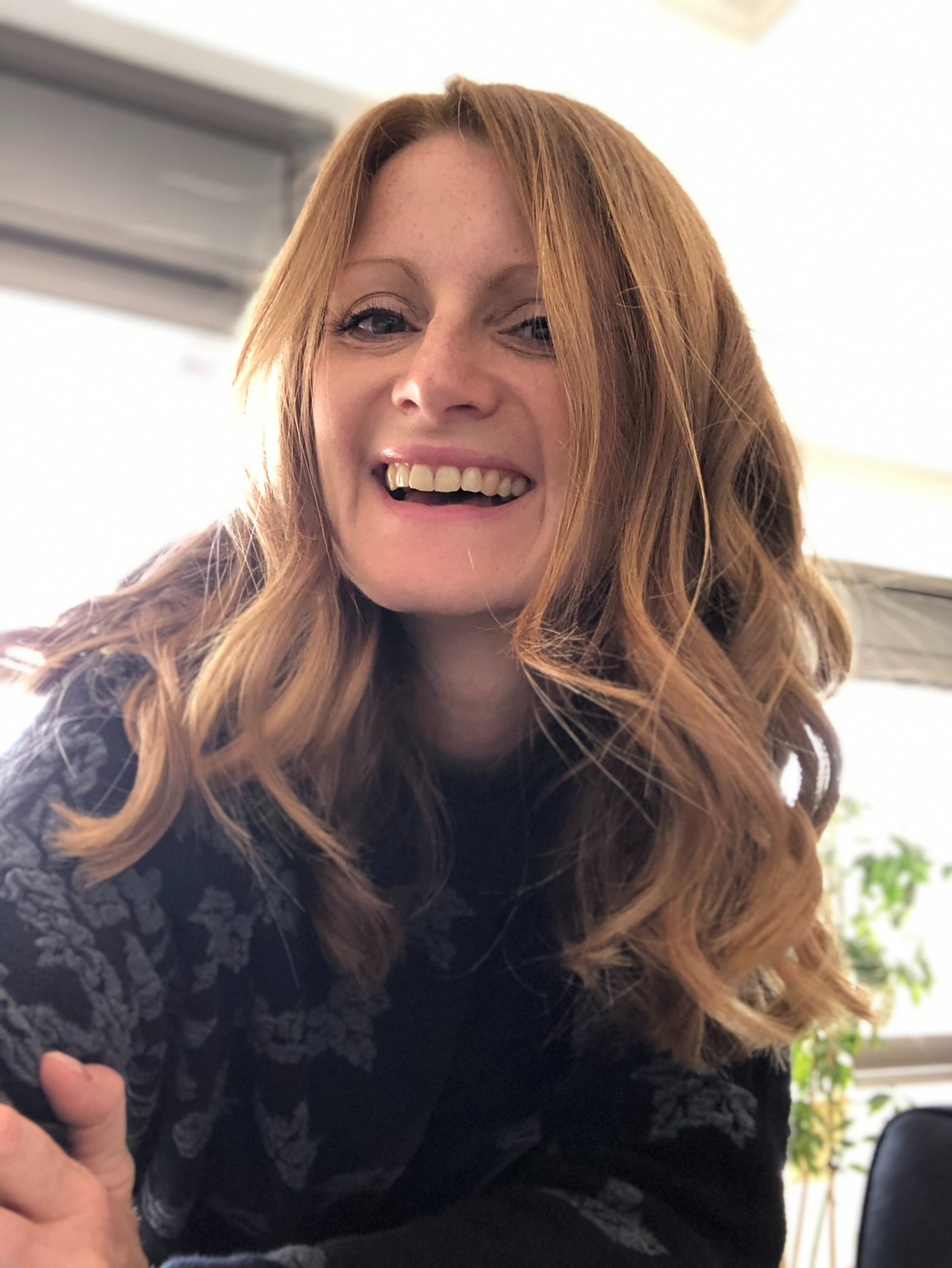 Picture of Helen: A woman with auburn hair and hazel eyes, smiling at the camera. 